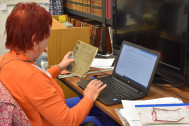 Photo of collections volunteer at a computer