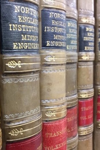Closeup on spines of leather books, all reading 
